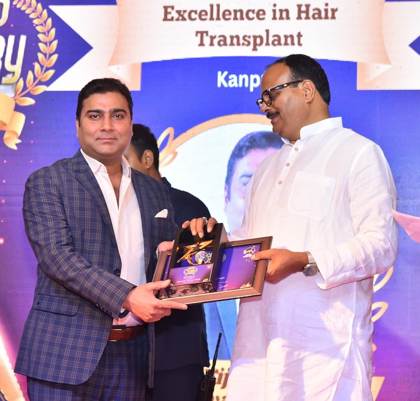 Dr. VK Singh receiving the Excellence in Hair Transplant Award 2023 from the Deputy Chief Minister of Uttar Pradesh, Brajesh Pathak